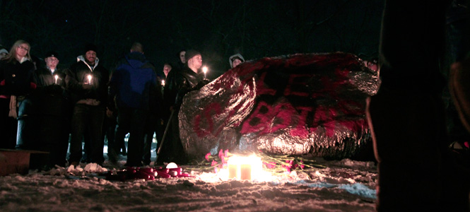 Family and friends gather at the front campus rock Monday night to remember junior Alexander Stebbins, who died Dec. 26. Stebbins was a member of Tau Kappa Epsilon.
