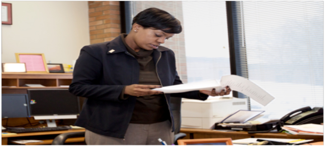 Timeka Rashid, the newly appointed associate dean of Student Affairs, looks over papers on Tuesday. Photo by Thomas Song.