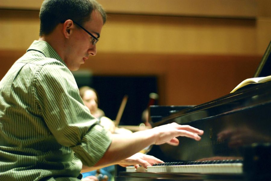 Richard Jeric, Kent State Concerto Competition undergraduate winner, practices Ravel’s “Piano Concerto in G” with the orchestra on Thursday. This was the same piece that won him the undergraduate portion of the competition. Photo by Sam Verbulecz.
