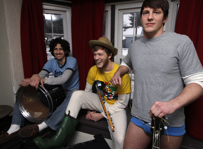 Dylan Gomez, Andrew Bittaker and Allen Bittaker, all members of the Kent rock group Tape-Toons sit in a bay window Sunday. The group plays music throughout northeast Ohio and is scheduled to be on Black Squirrel Radio Feb. 10.. Photo by Nikolas Kolenich.