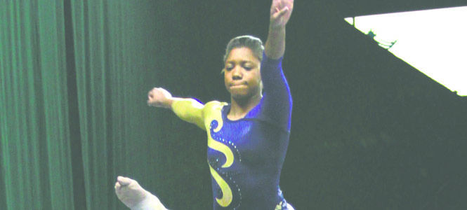 Freshman+Nikki+Moore+performs+a+split+in+mid-air+on+the+balance+beam+as+she+performs+at+a+quad+meet+in+Cleveland.+She+earned+a+9.050+for+her+routine+and+came+in+22nd+overall..+Photo+by+Lindsay+Frumker.