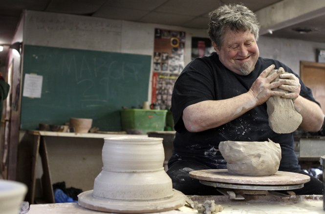 Associate+professor+Kirk+Mangus+demonstrates+how+to+make+various+dining+pieces+in+the+ceramics+lab+on+Monday.+Mangus+is+the+head+of+the+ceramics+department+at+Kent+State.+Photo+by+Nikolas+Kolenich
