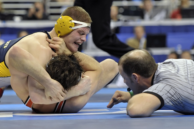 Dustin Kilgore of Kent State University wrestles Clayton Foster of Oklahoma State University during the Division I Mens Wrestling Championship held at the Wells Fargo Center in Philadelphia, PA. Kilgore defeated Foster by fall to win the 197 pound national title. Photo courtesy of Drew Hallowell/ Associated Press.