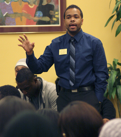 Bruce Mitchell, assistant director of Upward Bound Classic, addresses the crowd at the emergency Black United Students meeting held in the Multicultural Center Tuesday. Mitchell asked, What legacy will you leave behind? Photo by Valerie Brown.