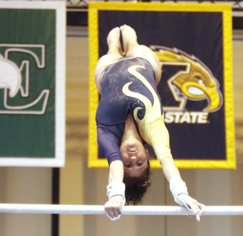 Senior Christine Abou-Mitri perfroms on the uneven bars Saturday at the M. A. C. Center. Abou-Mitri socred a 9.750 on the uneven bars during the Flashes 195.100-194.875 loss to Central Michigan. Photo by Jessica Yanesh.