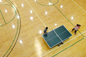 A few members play pingpong on the floor of the open gym at Kent State’s Student Recreation and Wellness Center. The courts are used for basketball, volleyball and a number of other sports and activities. FILE.