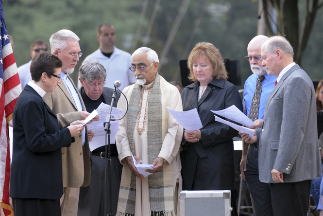 Civic and religious leaders sing during a September 11th commemoration yesterday September 8th at Home Savings Plaza in downtown Kent. The commemoration was before the weekly concert held in the plaza. Photo by Phil Botta.
