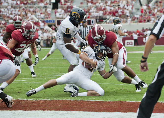 Alabama+offensive+players+tackled+Kent+States+defensive+lineman+Roosevelt+Nix+at+the+away+game+on+Saturday+September+3%2C+2011.+The+Flashes+fell+to+the+Crimson+Tide+48-7.+Photo+by+Drew+Hoover.