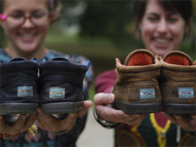Senior fashion design major Rita Yoder and junior fashion merchandising major Adrienne Landan held out the TOMS they have worn and will wear everyday for 365 days. Photo by Monica Maschak.