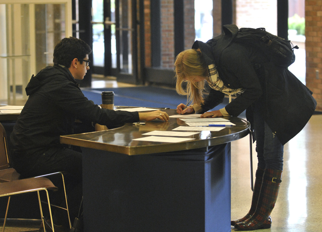 Sophomore architecture major Andrew Rasner invited Freshman nursing major Alli Hofrichter to become a registered voter in Portage County. Rasner represented undergraduate student government in promoting students to register to vote. Photo by Jenna Watson.