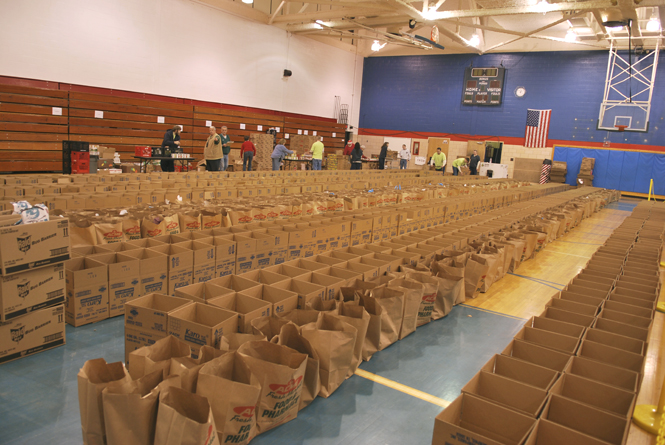 Toys and food fill the gymnasium of the old Ravenna High School in Ravenna in preparation for over 900 Portage County families in need of help this holiday season. The Center of Hope will be giving away the donations to families next Wednesday, Dec. 14. Photo by Monica Maschak.