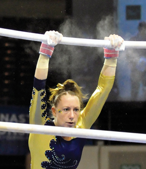 Rachel Guida performs acrobatics on the uneven bars at the Wolstein Center for the NCAA Gymnastics Championships on April 14, 2011. Photo by Philip Botta.