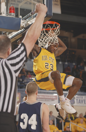 Junior forward Patrick Jackson hangs on the net after a dunk against Shawnee State on Jan. 2. Photo by Matt Hafley.