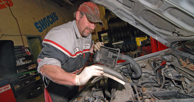 Jamie Nicely, 42, checks the air filter on a Honda Civic at Tires and More, located at 1556 South Water Street. 