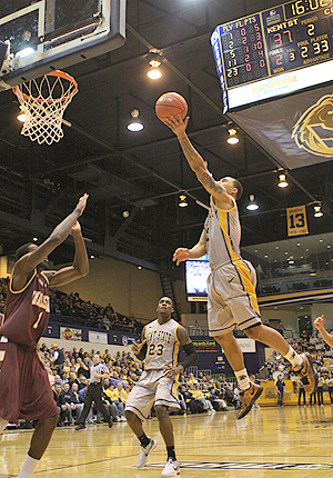 Senior guard Michael Porrini goes for a lay-up during the Flashes game against Charleston on Feb. 18. Porrini scored eight points in the Flashes 80-73 defeat. Photo by Coty Giannelli.