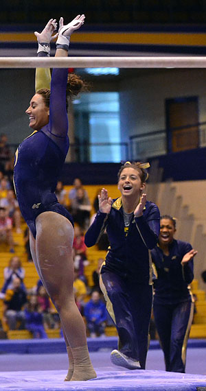 Freshman Kesley Lawless, landed a 9.725 on bars, March 10. Kent State came out with a win against Bowling Green at the M.A.C. Center. 196.400-193.525. Photo by Emily Martin.