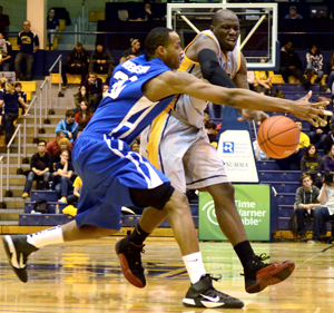 Kent State forward Justin Greene passes the ball past his defender in a game against Buffalo at the MAC Center Tuesday, Feb. 14. The Flashes defeated the Bulls 76-71 in a key Eastern Division game. Photo by Monica Maschak.