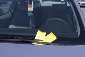A car sits with parking tickets in the Bowman Hall parking lot. Over three thousand tickets have been issued in the parking lot since the fall semester. Photo by Brian Smith.