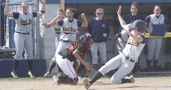 File photo. The Flashes greet junior shortstop Mary Holt at the plate after she scored the winning run off of a base-clearing double by junior 3rd baseman Jessica Blanton on Sunday, April 10. The Flashes had a five-run seventh inning and defeated Northern Illinois 8-7. Photo by Jessica Yanesh.