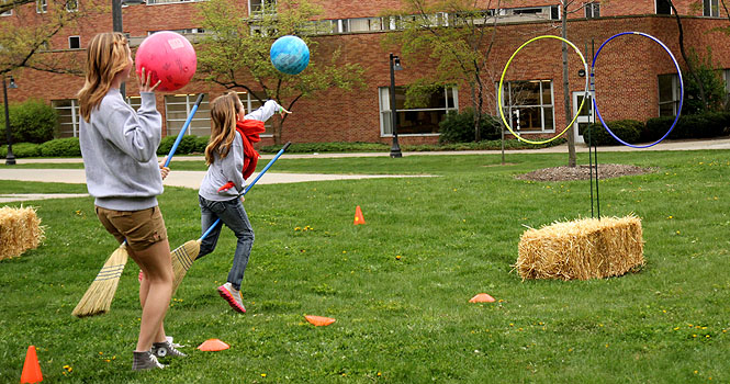 Aislinn Janek, a freshman fine arts major plays Quidditch with Zoe Bailey, 10 at Quadwarts on April 14. Little Sibs weekend had many events and activities that took place all over campus. Photo by Adrianne Bastas.