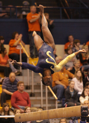 Kent State gymnast Felicia Charles flips on the balance beam during the March 11 game against Bowling Green. The Kent Flashes won against the Bowling Green Falcons at the meet. Photo by Brian Smith.