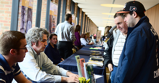 Sam Kaufman stands with his son, Andrew, 17, at one of the booths set up for prospective students on Friday. Kaufman intends to major in business management and is from Cherry Hill, New Jersey. Photo by Jacob Byk.