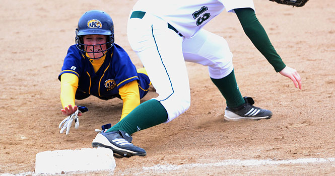 Abbey Ledford, sophomore 2nd and 3rd baseman, slids safely back into 1st base during saturdays game against eastern michigan, march 31. The flashes came out with a win 6-1. Photo by Emily Martin.