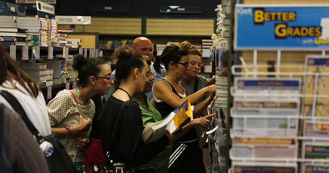 A group of students and parents search for textbooks they’ll need for the fall semester at the Campus Bookstore, located in the Student Center. The bookstore offers other supplies students may need and is a certified Apple computer store. Photo by Coty Giannelli.