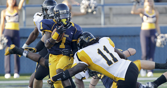 Senior runningback Dri Archer attempts to break a tackle from Towson during Kents first game on August 30. The Flashes will play at Buffalo at 7 p.m. on Wednesday. Photo by Phillip Botta.