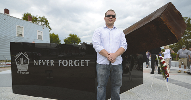 Michael Work, Kent State architecture graduate, was the main designer for the Police and Fire All Patriots 9/11 Memorial in Tiffin, OH. The memorial features a steel beam that was part of one of the World Trade Center buildings, which is angled on a pentagon-shaped base at 9.11 degrees. The memorial, located at the intersection of N. Washington St. and Frost Pkwy, was dedicated on Sunday, Sept. 9 after a solemn progression by Tiffin police and firefighters from St. Joesphs Church. Photo by Matt Hafley.