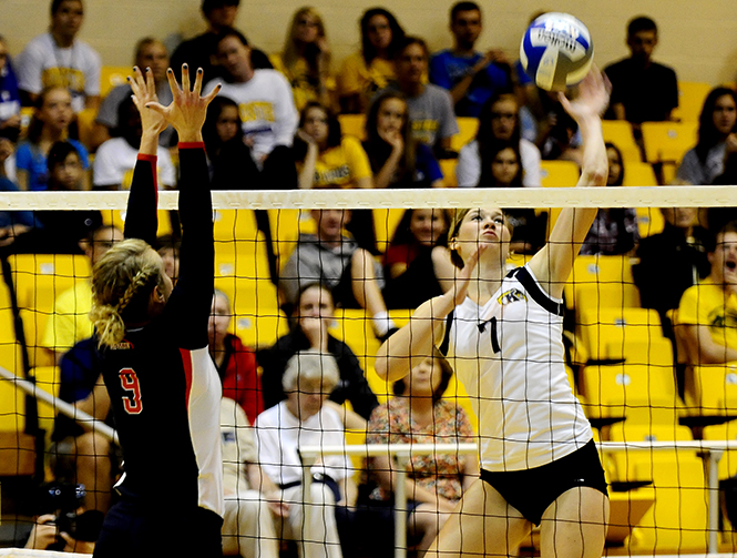 Freshman+Kelly+Hutchison+spikes+the+ball+over+the+net+during+Fridays+game+against+Liberty.+Photo+by+HANNAH+POTES.