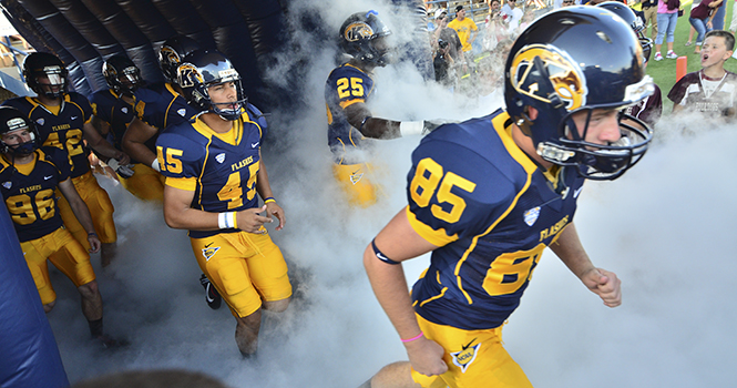 The+Kent+State+football+team+runs+out+to+the+field+at+Dix+Stadium+on+Aug.+30+ready+to+battle+against+Towson.+Kent+State+won+the+game+41-21.+Photo+by+Jacob+Byk.