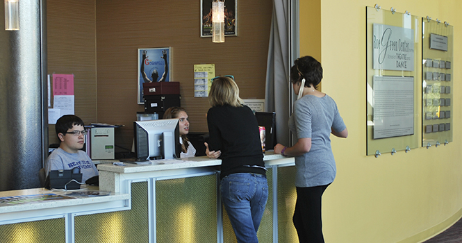 Theater studies major Cullen Motok and Amanda Welly, American Sign Language and Educational Interpreting major, help Margaret Peebles (left) and Carly Shiner (right) at the newly built box office in the Roe Green Center in the College of Music and Speech. Photo by Rachael Le Goubin