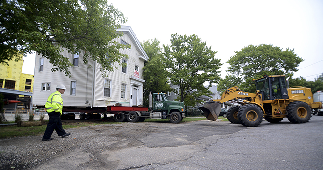 The Stein Movers company pulls the Wells Sherman house over the curb onto a lot next to the Haymarker Parkway and Depyster St. intersection. The house now sits on a gravel lot at the west . Photo by Matt Hafley.