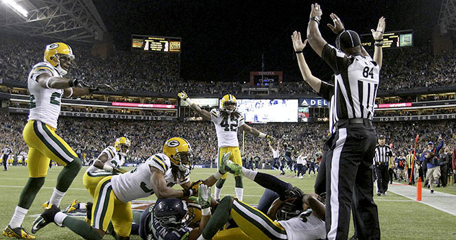 Referees signal different calls after Monday nights game-ending play. It was finally ruled a touchdown, giving the Seahawks a 14-12 win to defeat the Green Bay Packers at CenturyLink Field on Monday, September 24, 2012, in Seattle, Washington. Photo courtesy of MCT Campus.