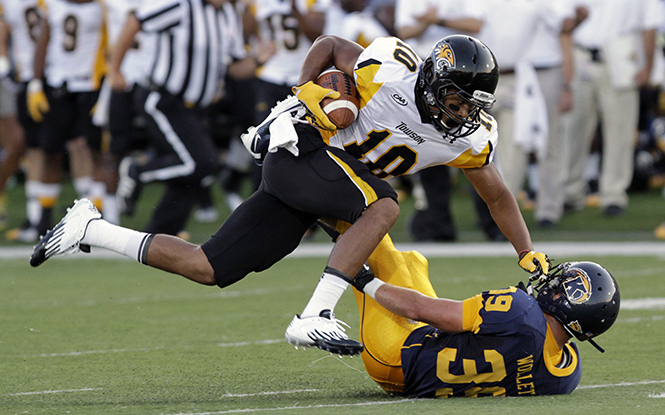 Towson player Spencer Wilkins runs into Kent player Luke Wollet during the Aug. 30 at Dix Stadium. Kent State won the game 41-21. Photo by Phil Botta.