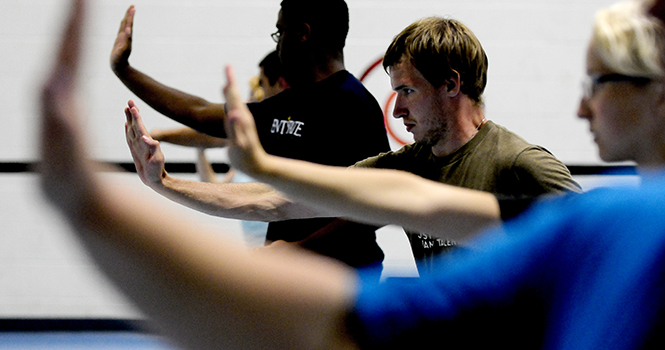 Junior David Schoonover practices martial arts maneuvers during the Green Dragon Kung Fu Club at the Gym Annex Wednesday evening. Photo by Hannah Potes.