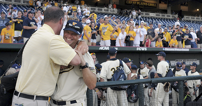 Head Coach Scott Stricklin celebrates with members of his team, family and support staff after beating the number one ranked Florida, Monday June 18, in Omaha, Neb. Stricklin renewed his contract with Kent State for another six years. Photo by Philip Botta.