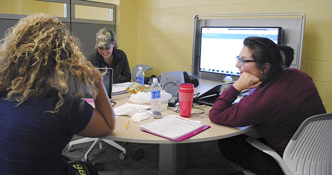 Sophomores Allison Delsanter, Emma Glenn and Rachel Smeaton use one of the interactive conference areas for a group study on the fourth floor of the library on Friday, September 21. The study areas are free and easy to use, with a plug in for a computer to view on the large screen. Photo by Jenna Watson
