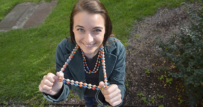 Bonnie Burhoe, senior park management major, shows off the necklace she bought while on the Uganda Study Abroad trip last spring. Photo by Jacob Byk.
