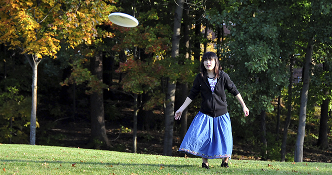 Mio Suzuki, an exchange student from Japan, learns and practices to how play Ultimate Frisbee on the Centennial field Thursday evening. Suzuki decided to join in with the newly created Kent State Womens Ultimate Frisbee team after watching the team practice. Photo by Jessica Denton.
