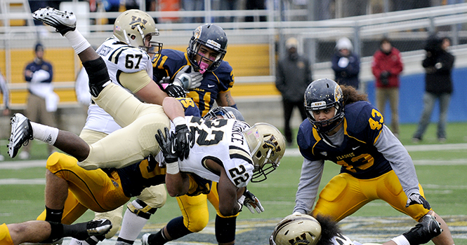 Sophomore wide receiver Skevo Zembillas tackles a Western Michigan player to the ground during KSUs homecoming game Saturday afternoon. Photo by Hannah Potes.