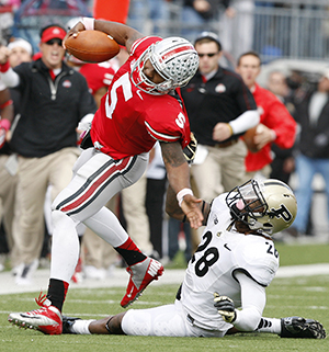 Purdue Boilermakers cornerback Josh Johnson (28) pulls down Ohio State Buckeyes quarterback Braxton Miller (5) during the third quarter of an NCAA football game at Ohio Stadium in Columbus, Ohio on Saturday, October 20, 2012. The Ohio State Buckeyes defeated the Purdue Boilermakers in overtime, 29-22. Photo by ADAM CAIRNS.