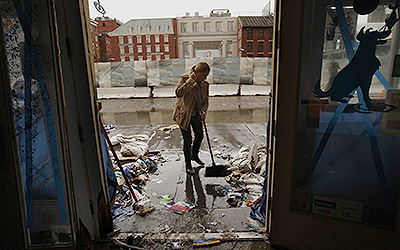 Amanda Zink starts to clean up the store she owns called The Salty Paw, which was completely flooded on the waterfront of lower Manhattan, Tuesday, October 30, 2012. The tape on the windows was no match for the strength of the storm. Hurricane Sandy caused major damage to New York City and surrounding areas. (Carolyn Cole/Los Angeles Times/MCT.