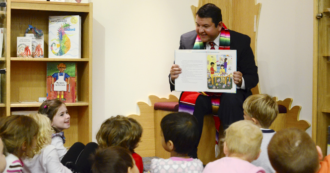 David Garcia, associate vice president for enrollment management, reads to children from the KSU Childrens Development Center in the Reinberger Childrens Library in the main library on Oct. 10. Garcia read the books in English and Spanish because he said it is important for them to hear the different languages during Hispanic Heritage Month. Photo by Nancy Urchak.