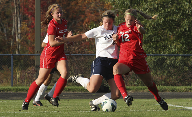 Kent State soccer player Madison Helterbran fights her way through the Ball State defense on Sept. 28 at Kent. The Flashes won the game 2-0. Photo by BRIAN SMITH.