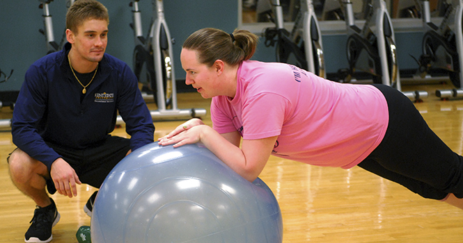 Jerry Guerriero, a personal trainer at the Kent State Rec Center, works with Rebecca Kapler during a short training session Friday, October 11 2012. Photo by Melanie Nesteruk.