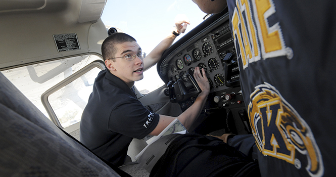 Senior aeronautics major Conrad Pflasterer goes over flight controls during on October 9. Kent State is hosting a flight competition throughout the week, where flight students from Kent and other colleges in the area will show off their flight and landing skills at the Kent State Airport. Photo by Daniel Enders.