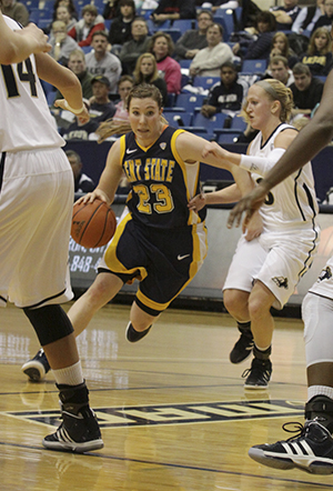 Kent Guard Jamie Hutcheson makes her way through the Akron defense during Jan. 14, 2012. Photo by Brian Smith
