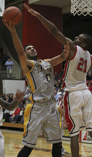 Kent State's Bryson Pope puts up a layup while being defended by Youngstown State's Damian Eargle during the second half of Wednesday nights matchup against Youngstown State in the Beeghly Center on the campus of Youngstown State University. Pope finished the game with three points and six rebounds in the Golden Flashe's 85-78 overtime victory in Youngstown. Photo by Dustin Livesay